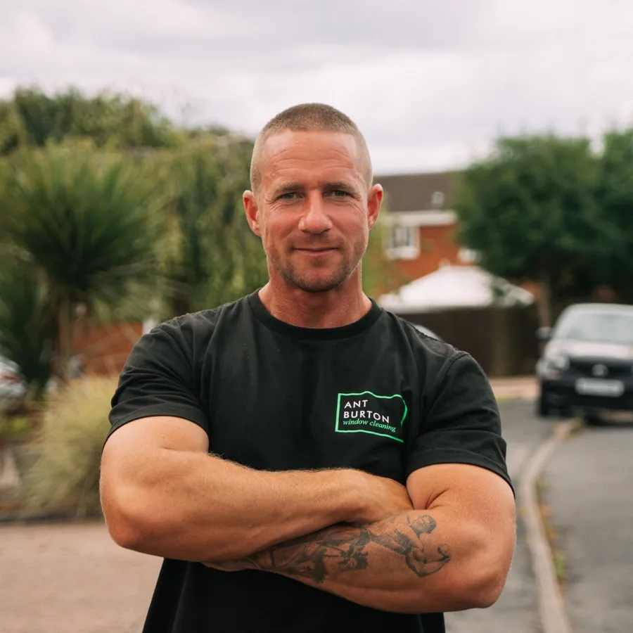 Ant Burton, arms crossed in his branded work t-shirt