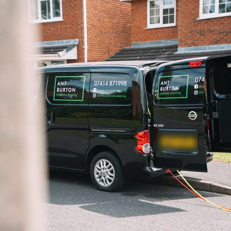 Rear doors open on the Ant Burton van, showing the on-board pure water hose system